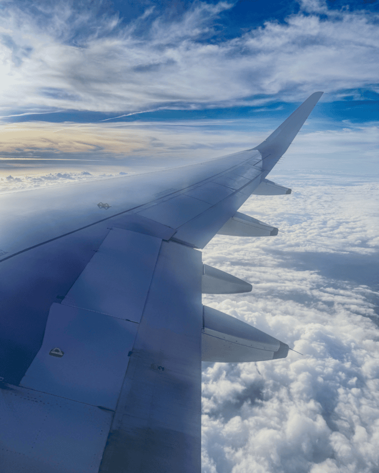 Airplane wing over the clouds on a flight