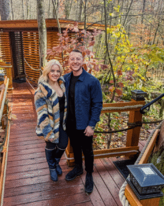 Courtney and Nick outside their treehouse dining pod at TreeTops Restaurant, a fall date spot near Pittsburgh