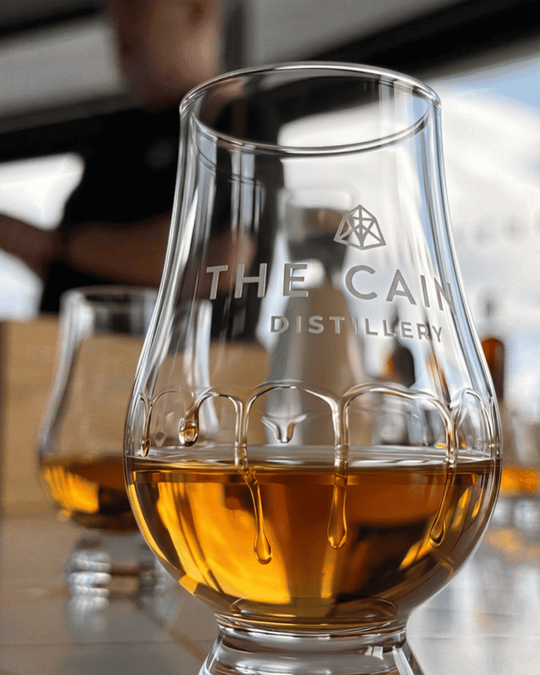 Whisky in a Glencairn glass etched with The Cairn Distillery logo during a tasting on the Speyside whisky tour from Inverness